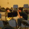 Brother Elliott teaching a young student about horn embouchure
